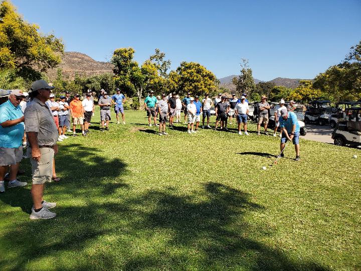 Brad Grossman teeing off with a one iron in the long drive